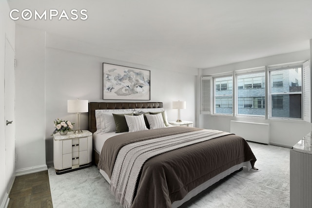 150 E 61st St Unit 5C, New York City, NY 10065 - bedroom featuring radiator and baseboards