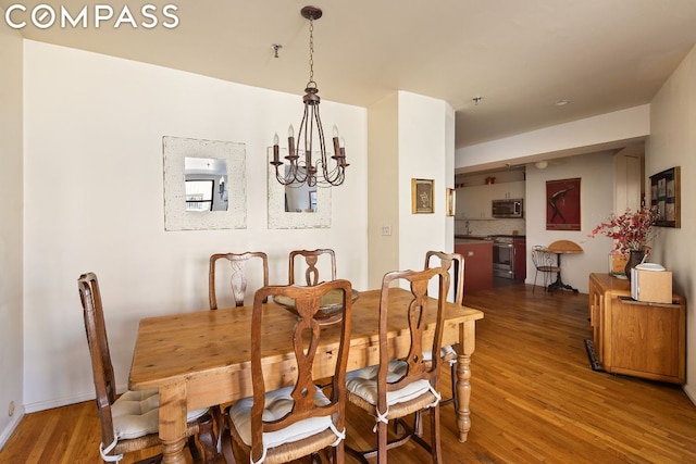 dining room featuring dark hardwood / wood-style floors and a notable chandelier