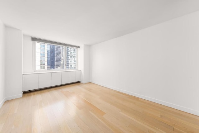 unfurnished room with light hardwood / wood-style floors