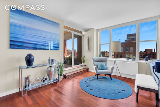 living area featuring baseboards and wood finished floors