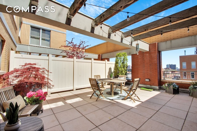 view of patio with fence, a pergola, and outdoor dining area