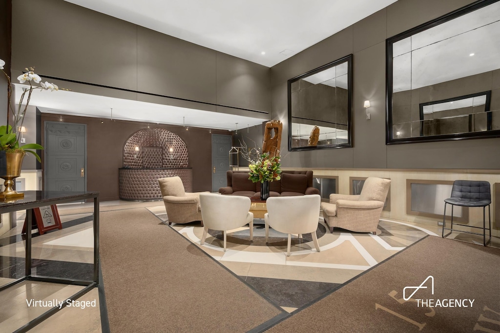 building lobby featuring a decorative wall and a towering ceiling