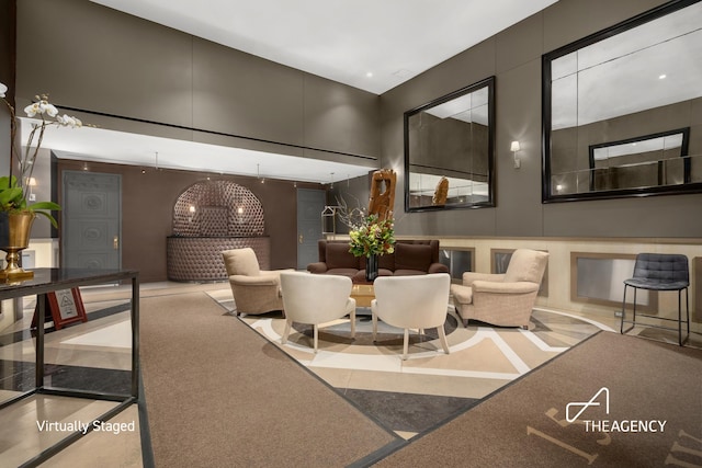 building lobby featuring a decorative wall and a towering ceiling