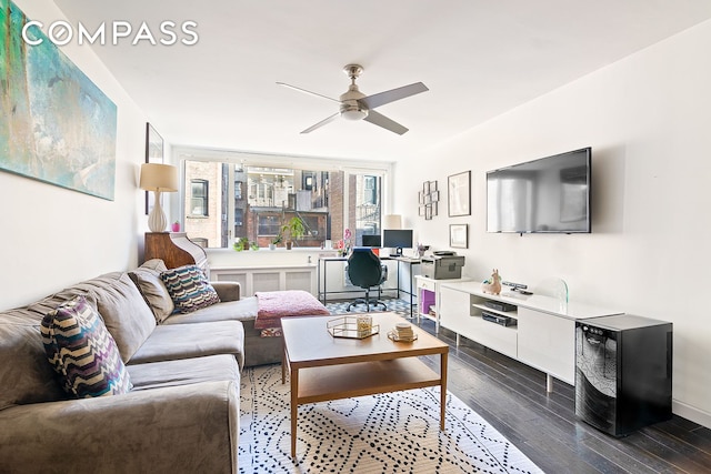 living area featuring a ceiling fan and wood finished floors