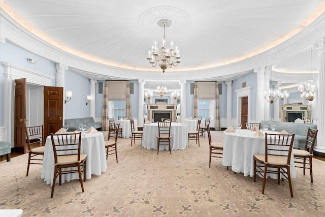 dining space with an inviting chandelier and decorative columns