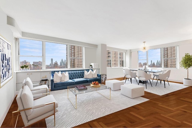 living area with baseboards and a city view