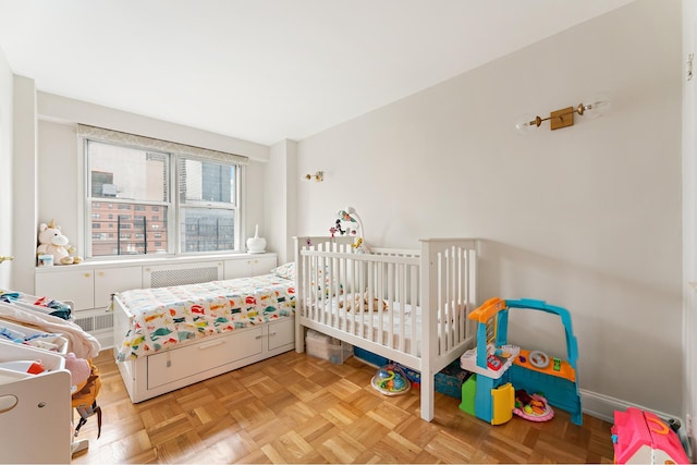 bedroom with baseboards and radiator