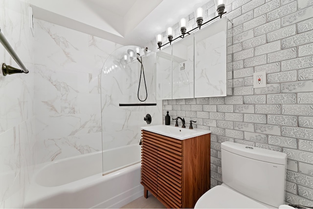 full bathroom featuring toilet, tile walls, bathing tub / shower combination, and vanity