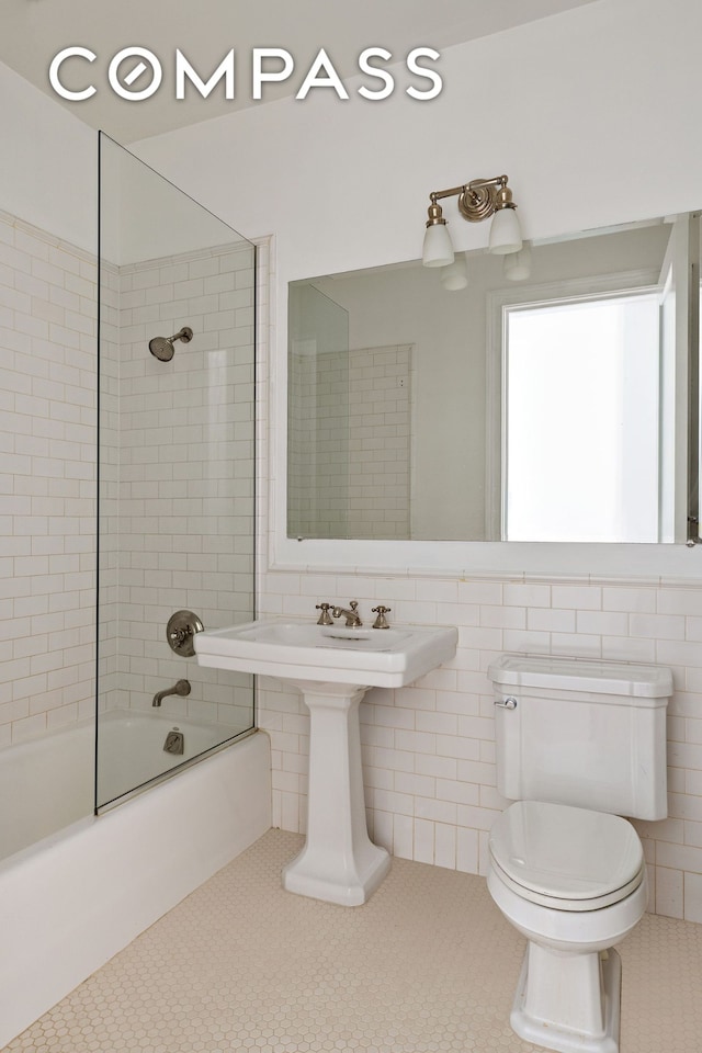 285 Lafayette St Unit 2B, New York City, NY 10012 - full bathroom featuring washtub / shower combination, tile patterned floors, and tile walls