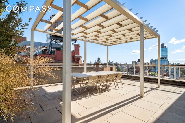 view of patio / terrace featuring a view of city and outdoor dining area