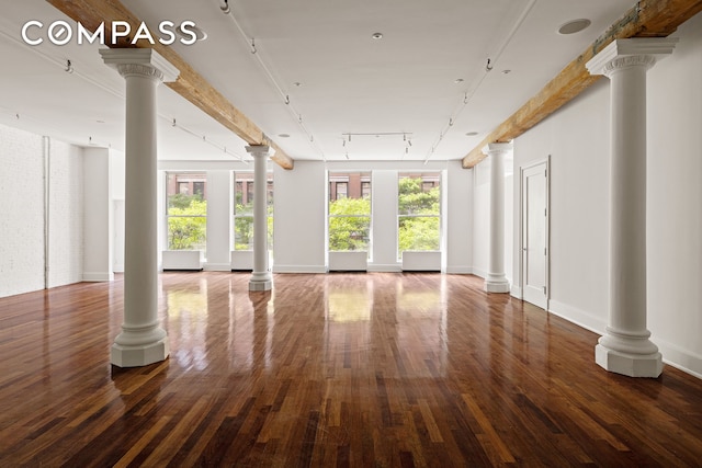 285 Lafayette St Unit 2B, New York City, NY 10012 - unfurnished living room featuring decorative columns, healthy amount of natural light, and wood finished floors