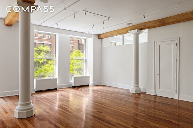 285 Lafayette St Unit 2B, New York City, NY 10012 - empty room featuring ornate columns, wood finished floors, and track lighting