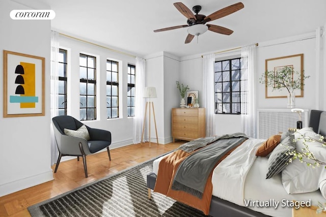 bedroom featuring ceiling fan and multiple windows