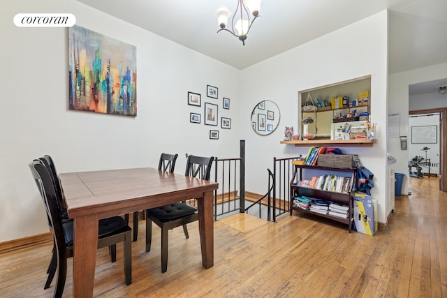 dining space with light wood-style floors, visible vents, and a notable chandelier