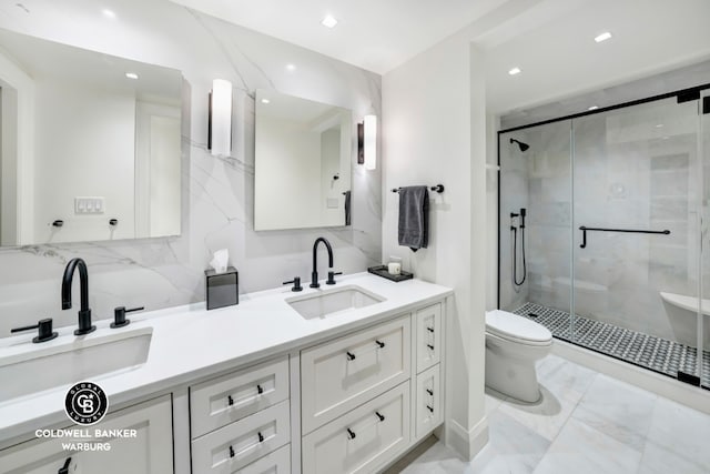 bathroom with vanity, a shower with shower door, and toilet