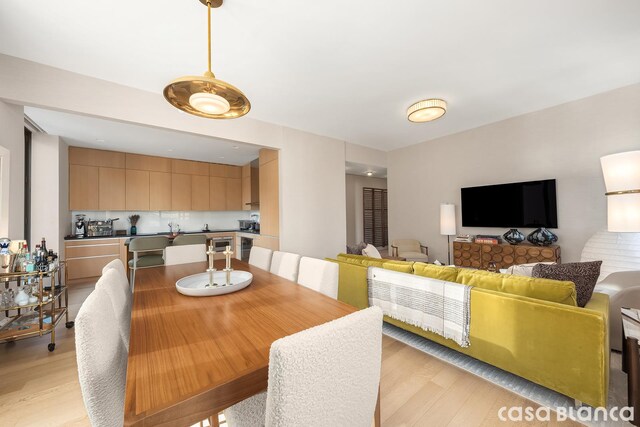 dining room featuring sink and light hardwood / wood-style floors