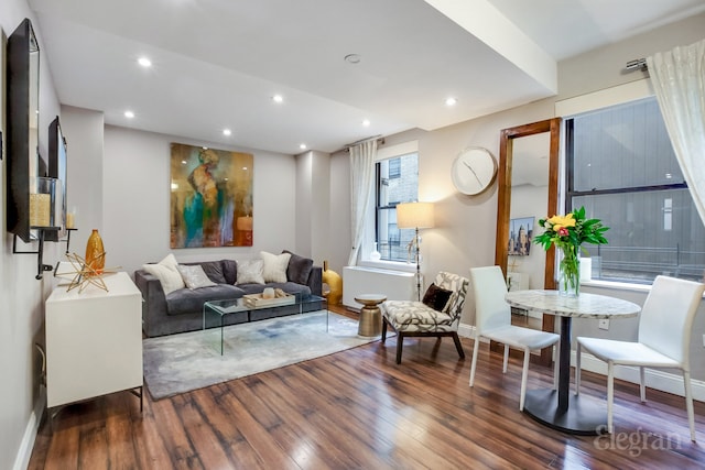 living area with recessed lighting, baseboards, and wood finished floors