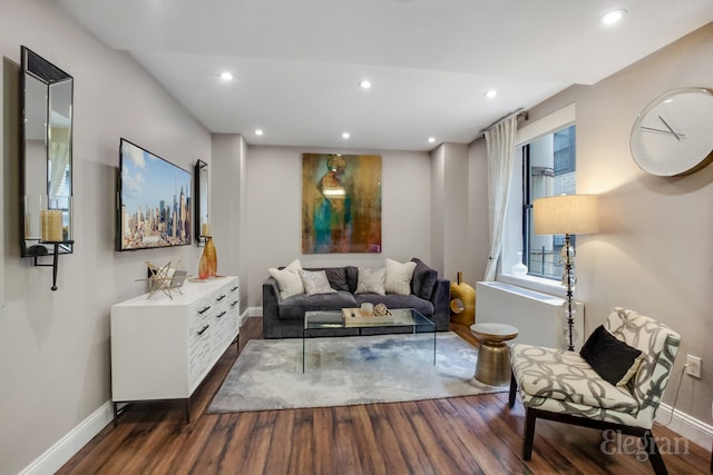 living area with baseboards, dark wood-style flooring, and recessed lighting