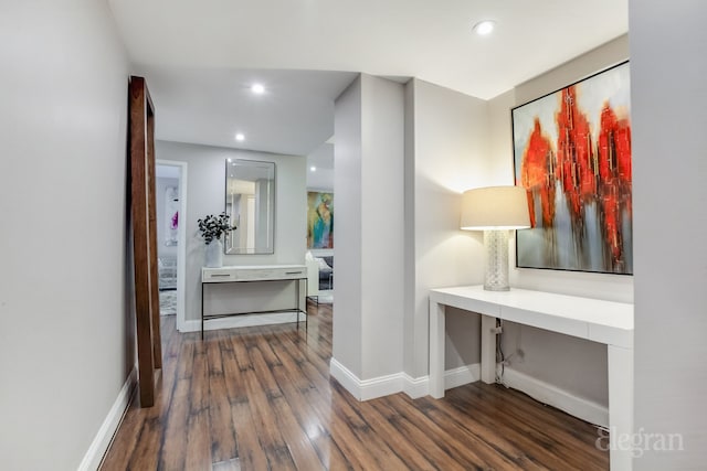 hall with baseboards, dark wood finished floors, and recessed lighting