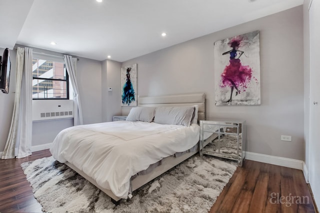 bedroom with baseboards, wood finished floors, and recessed lighting