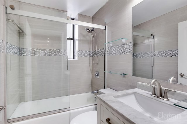 bathroom featuring shower / bath combination with glass door, vanity, and toilet