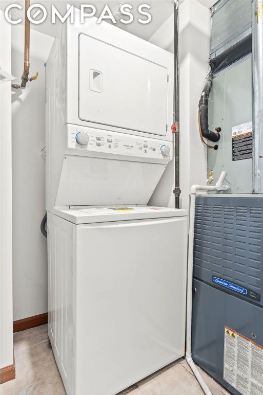 laundry room with stacked washer and clothes dryer