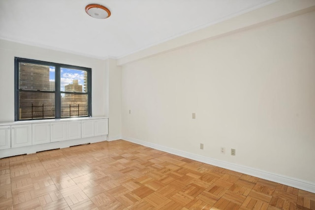 unfurnished room with light parquet flooring