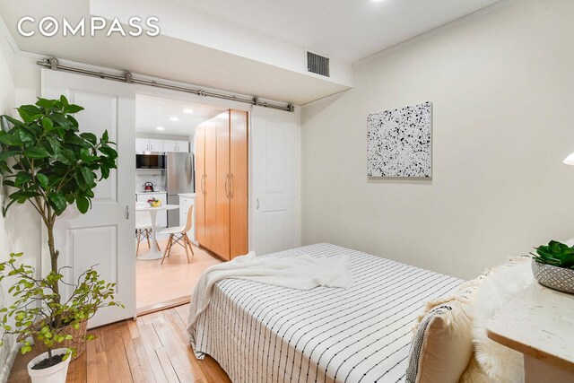 bedroom featuring light hardwood / wood-style floors