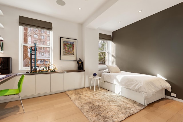 bedroom with light wood-style floors and recessed lighting
