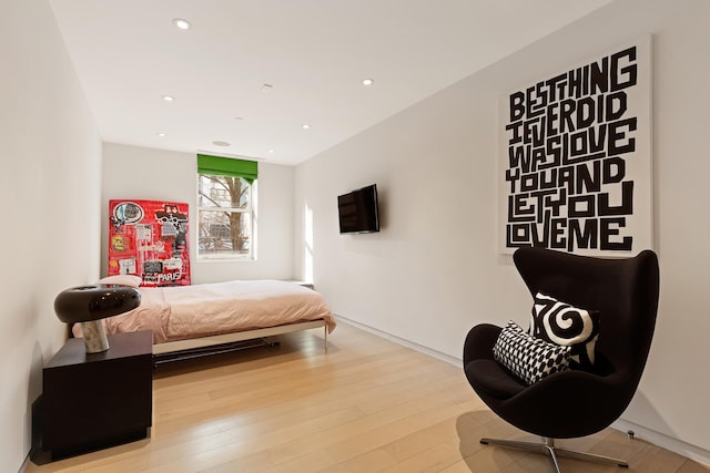 bedroom with recessed lighting, baseboards, and wood finished floors