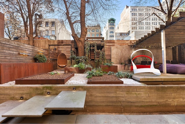 view of yard with fence and a vegetable garden