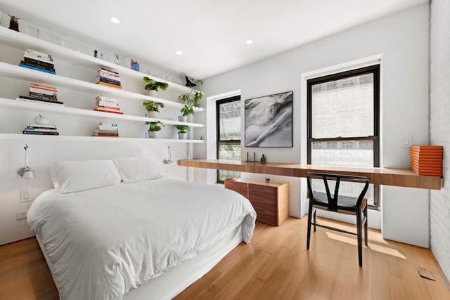 bedroom with wood finished floors and recessed lighting