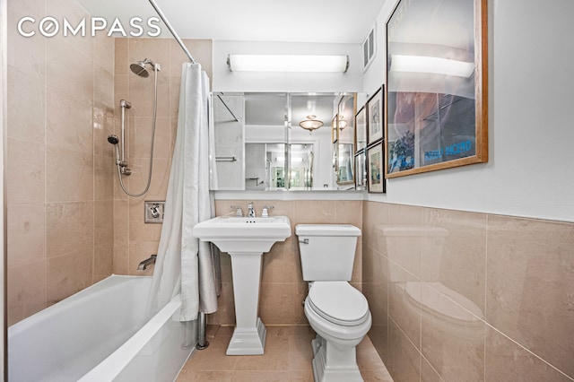 full bathroom with tile walls, tile patterned floors, toilet, shower / tub combo, and visible vents