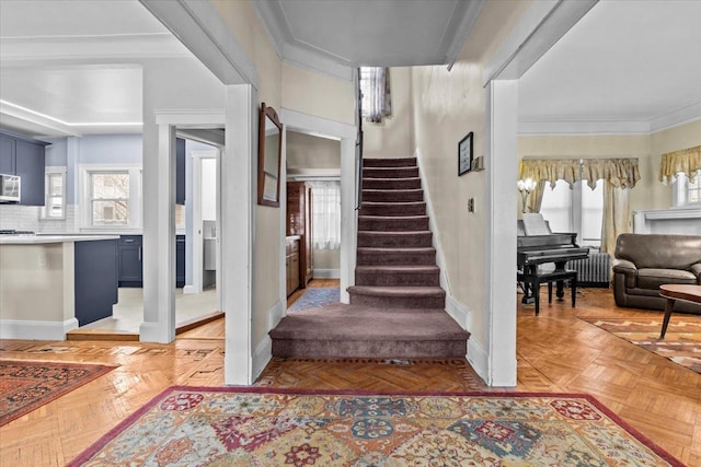 stairway featuring radiator, plenty of natural light, and baseboards