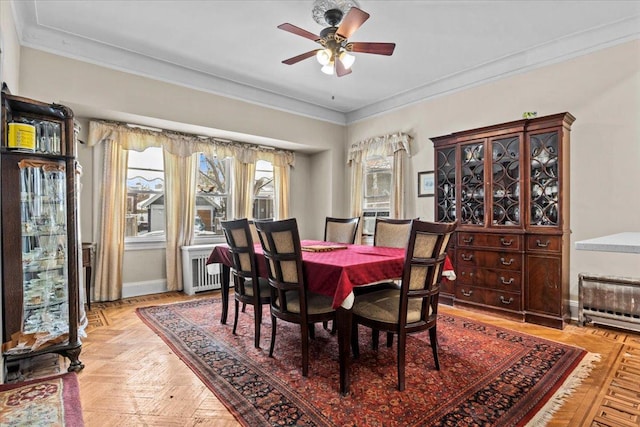 dining space with ceiling fan, ornamental molding, and baseboards