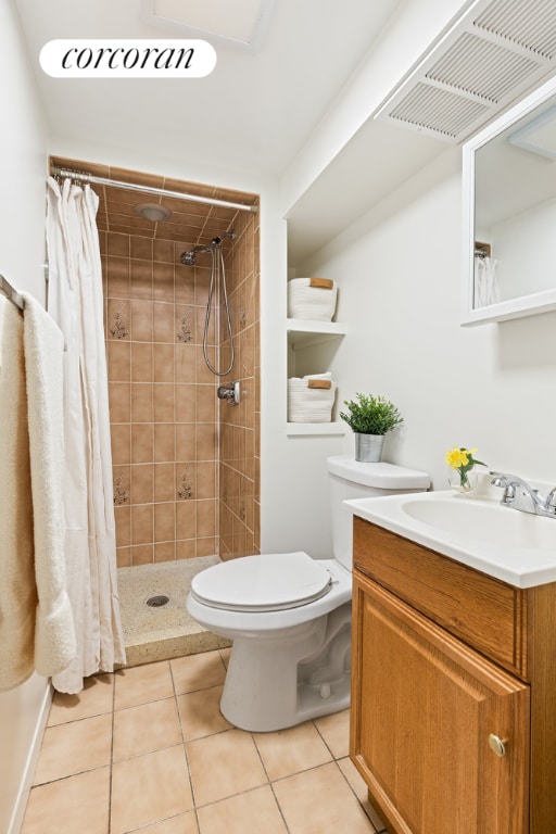 bathroom featuring tile patterned floors, toilet, a shower with shower curtain, and vanity