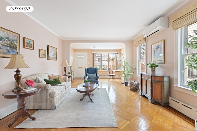 living room with light parquet floors, a baseboard radiator, plenty of natural light, and a wall mounted AC