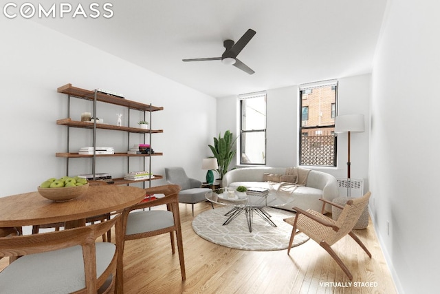 sitting room with ceiling fan and light hardwood / wood-style flooring