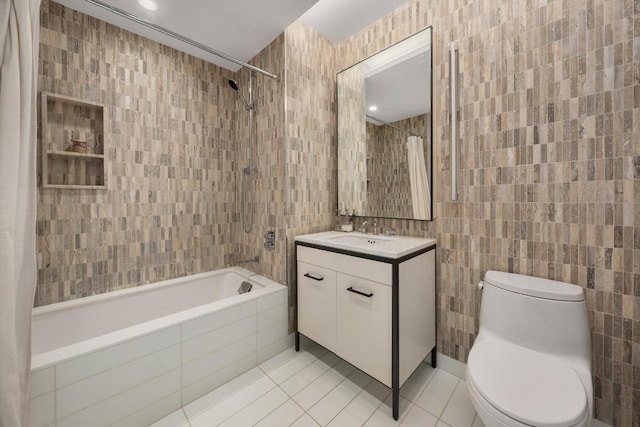 full bathroom with toilet, shower / tub combo, tile walls, vanity, and tile patterned flooring