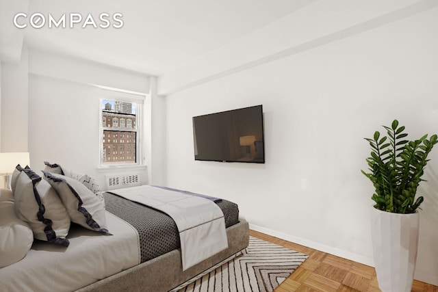 bedroom with light parquet flooring