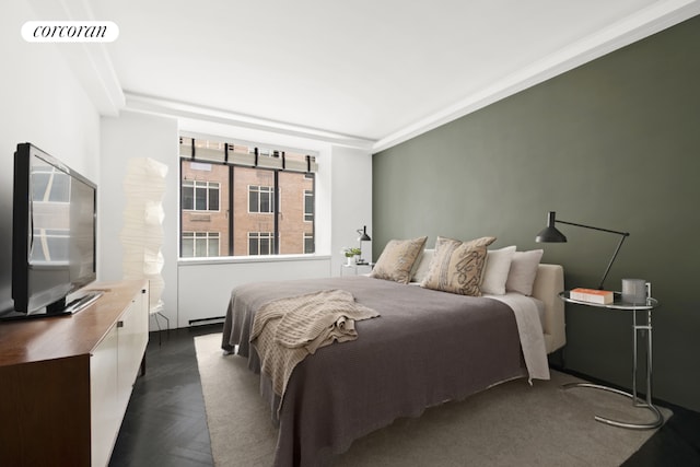 bedroom featuring dark parquet flooring and ornamental molding