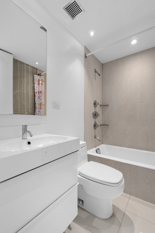 bathroom featuring visible vents, toilet, tile patterned floors, shower / bath combination with curtain, and vanity