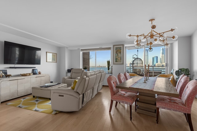 21 S End Ave Unit 321/421, New York City, NY 10280 - dining room with light wood-style floors and a chandelier