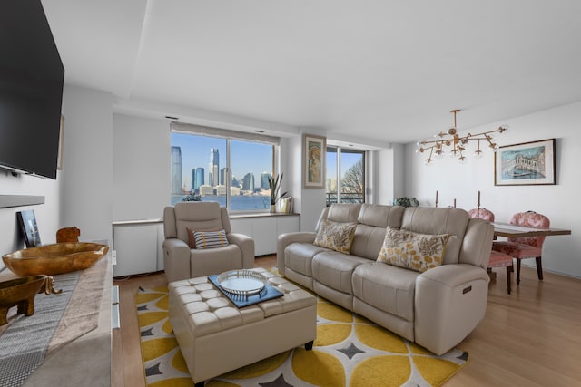 21 S End Ave Unit 321/421, New York City, NY 10280 - living room featuring light wood-style flooring and a skyline view