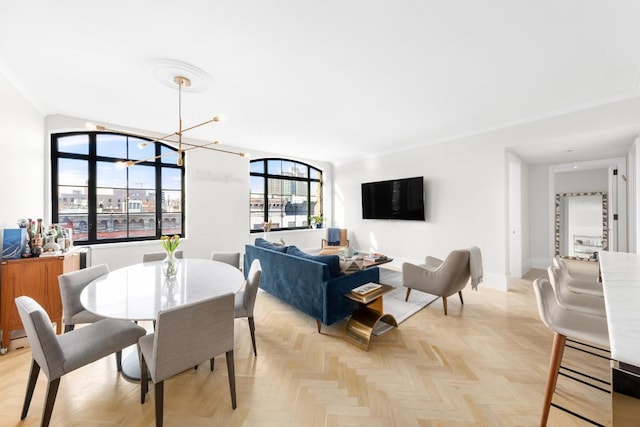 dining space featuring a chandelier and light parquet flooring