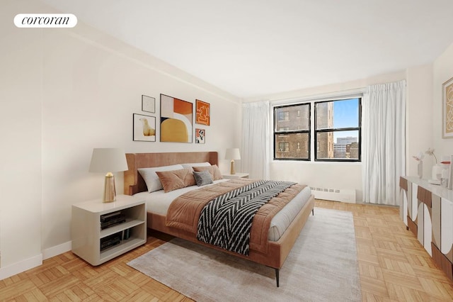 bedroom with a baseboard heating unit, baseboards, and visible vents