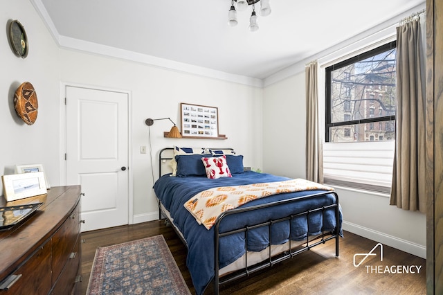 bedroom featuring dark wood-type flooring and baseboards