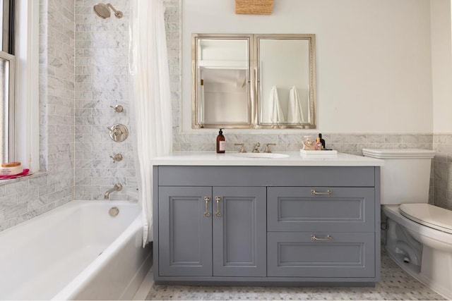 full bathroom with shower / tub combo with curtain, vanity, toilet, and tile walls