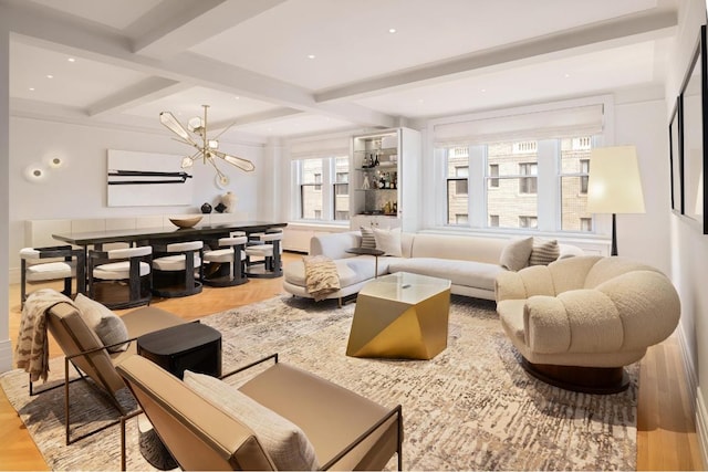 living room with coffered ceiling, a notable chandelier, light parquet flooring, and beamed ceiling