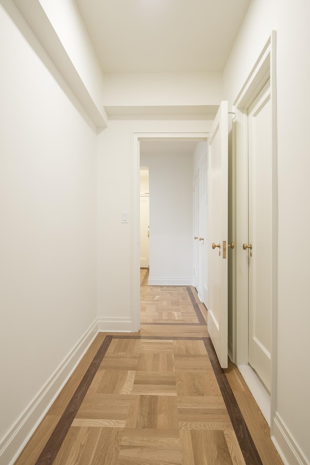 hall featuring baseboards